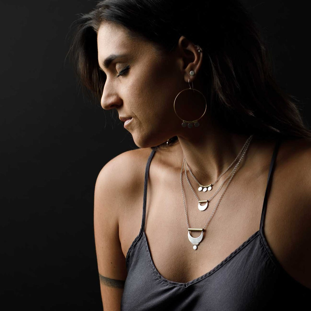 The Shatki Pendant layered with the Crescent Moon Pendant and the Large Prana Pendant.