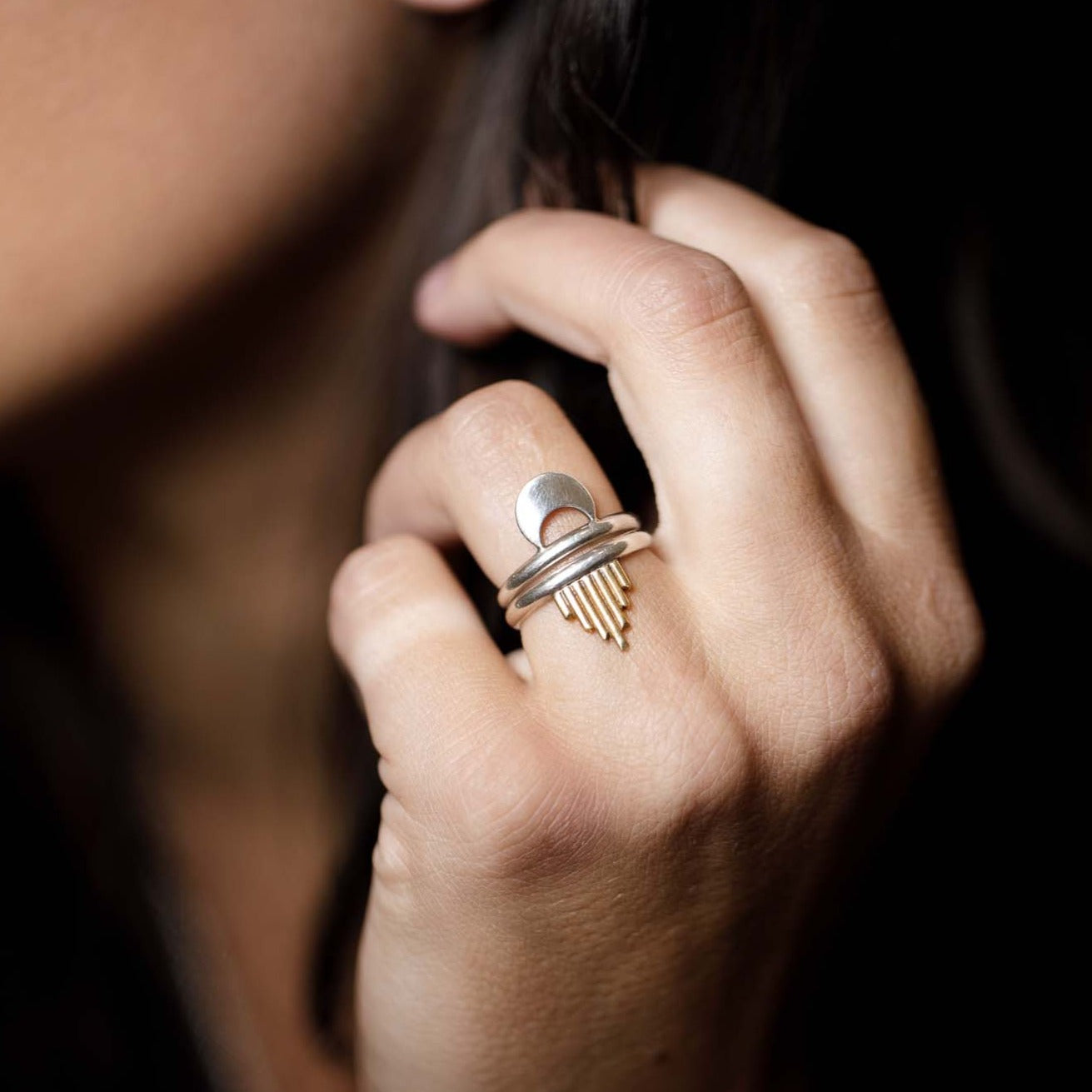 Close up of the Alchemy Ring Set to show off its details. The textural quality of the stylized brass sun ray is juxtaposed with the smooth silvery nature of the crescent moon ring.
