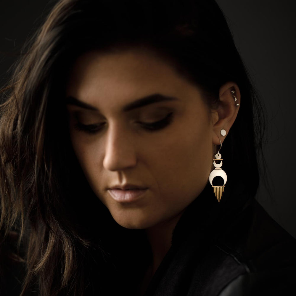 
                  
                    A statement earring paired with a minimal shiny dot stud for an added touch of femininity. 
                  
                