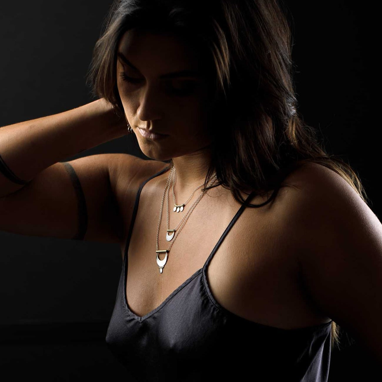 Feminine layering necklaces styled with a silk dress.