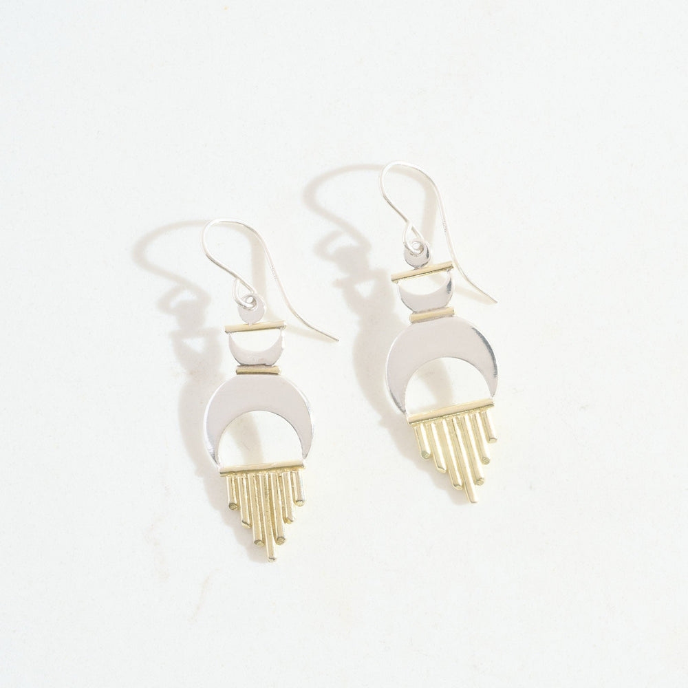 Pair of earrings with gold and silver design on a white background