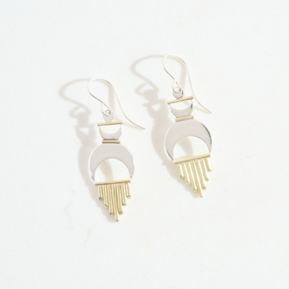 Pair of earrings with gold and silver design on a white background