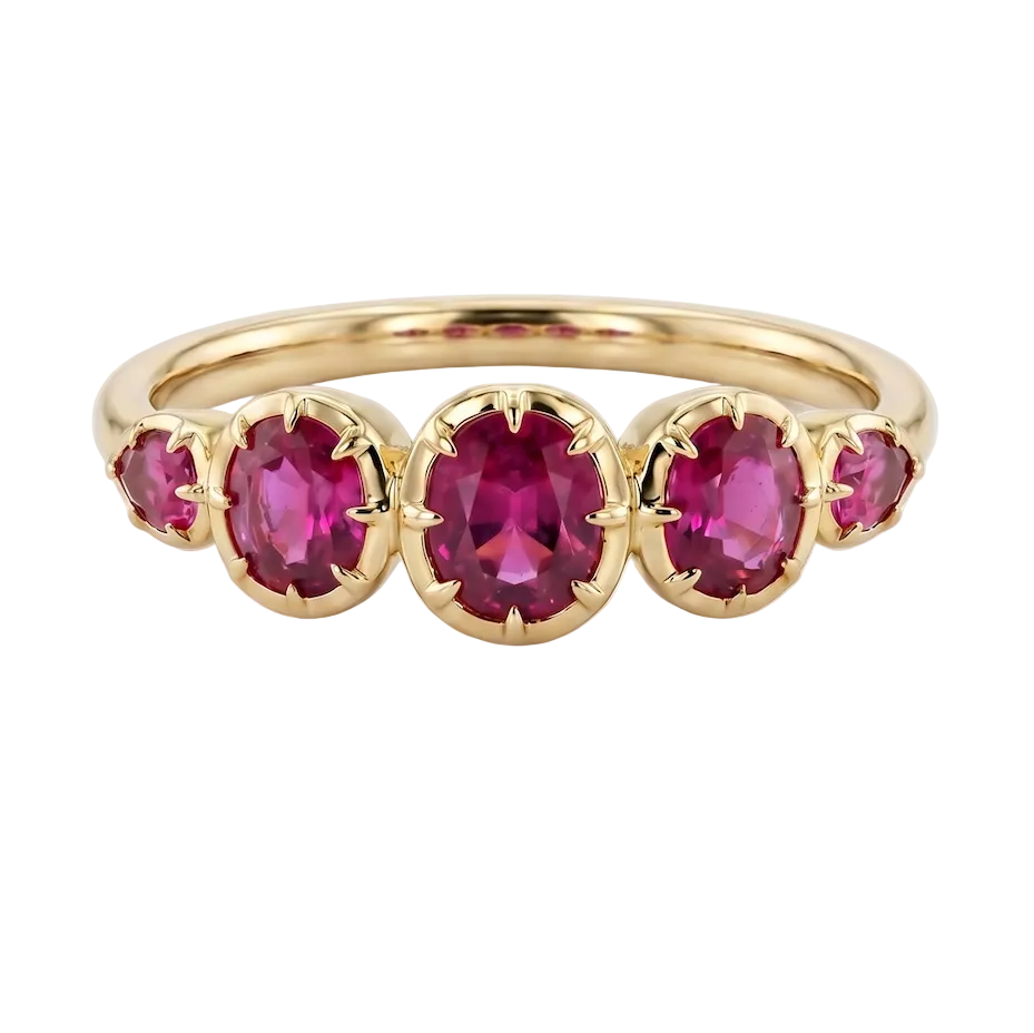 Gold ring with five red gemstones on a white background