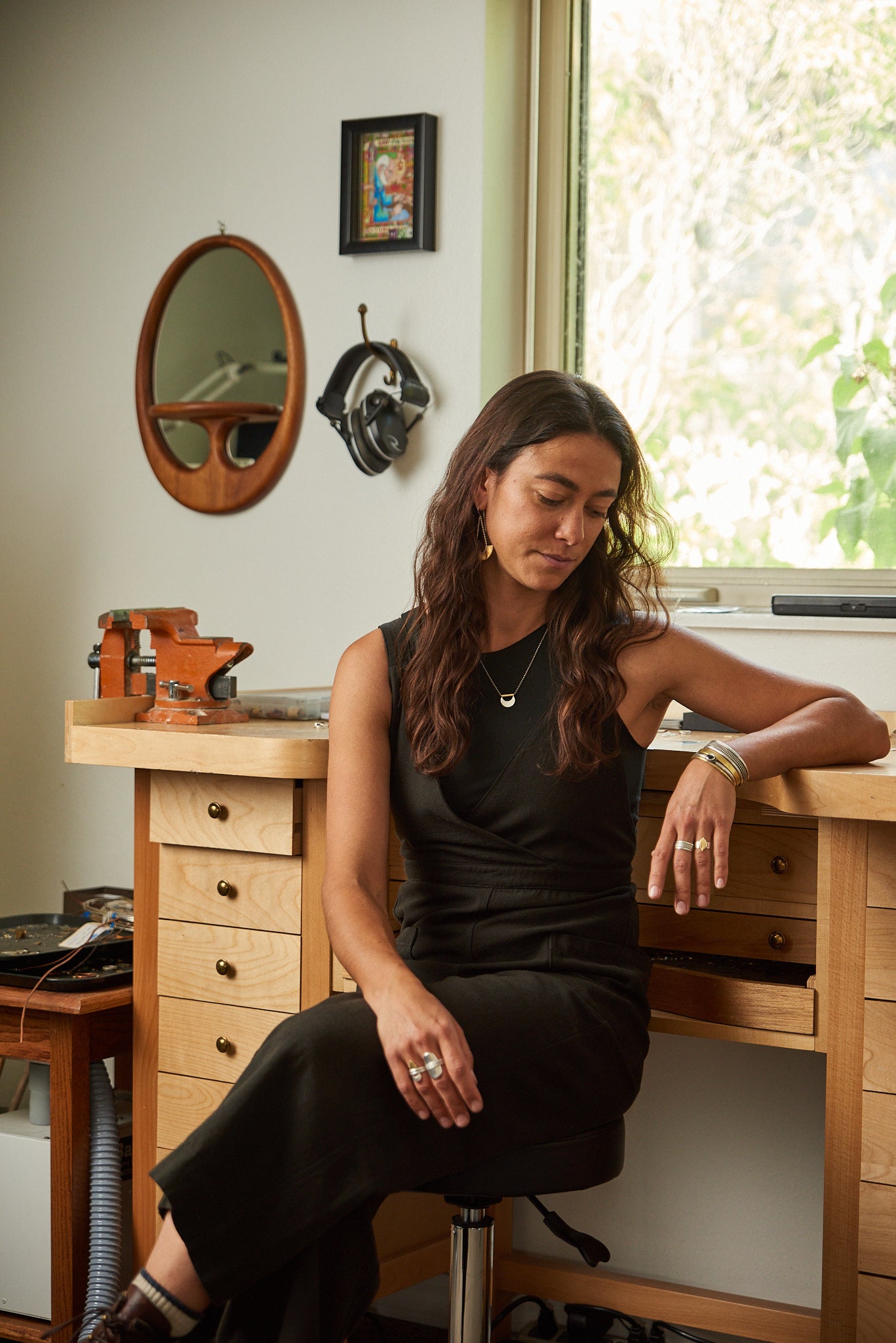 Woman sitting at a wooden desk in a home office setting