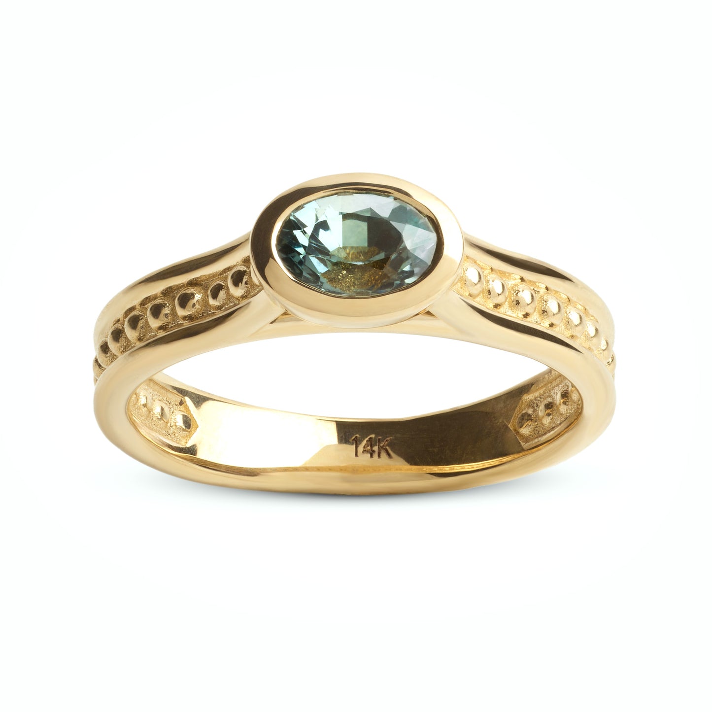 Gold ring with a teal gemstone on a white background