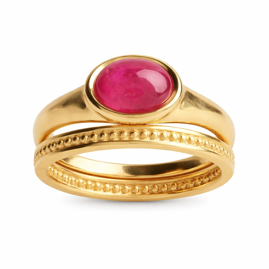 Gold ring with a pink gemstone on a white background