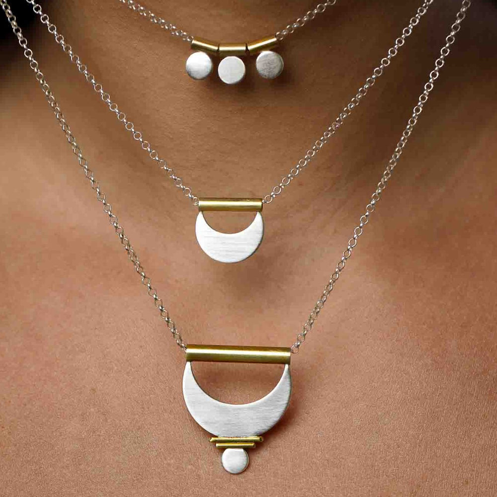 
                  
                    Three mixed metal layering necklaces shown close up to admire the geometry and craftsmanship. 
                  
                