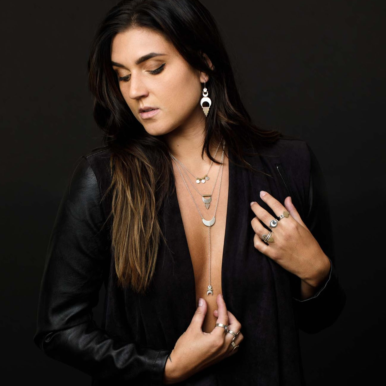 Alchemy Earrings styled with layered necklaces and rings from the Alchemy Collection. 