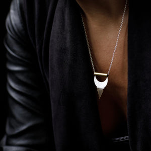 
                  
                    Dangling from her neck the Alchemy Pendant feels strong yet feminine. 
                  
                