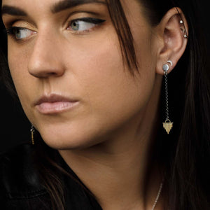 
                  
                    Wearing the Sun Ray Dangle Studs paired with the Small Crescent Moon Studs as a second piercing. 
                  
                