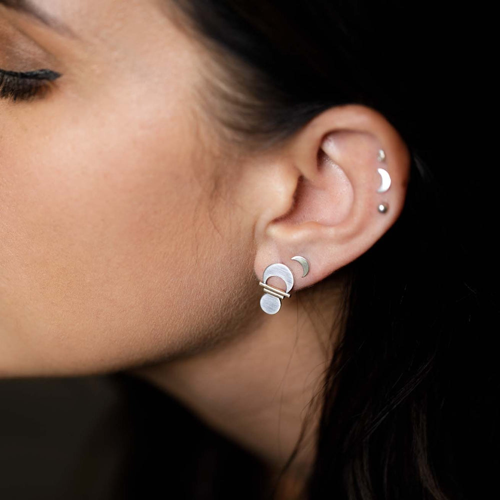 
                  
                    Wearing the Prana Studs layered with Small Crescent Moon Studs  as a way of incorporating symbols of the divine feminine into multiple piercings.
                  
                