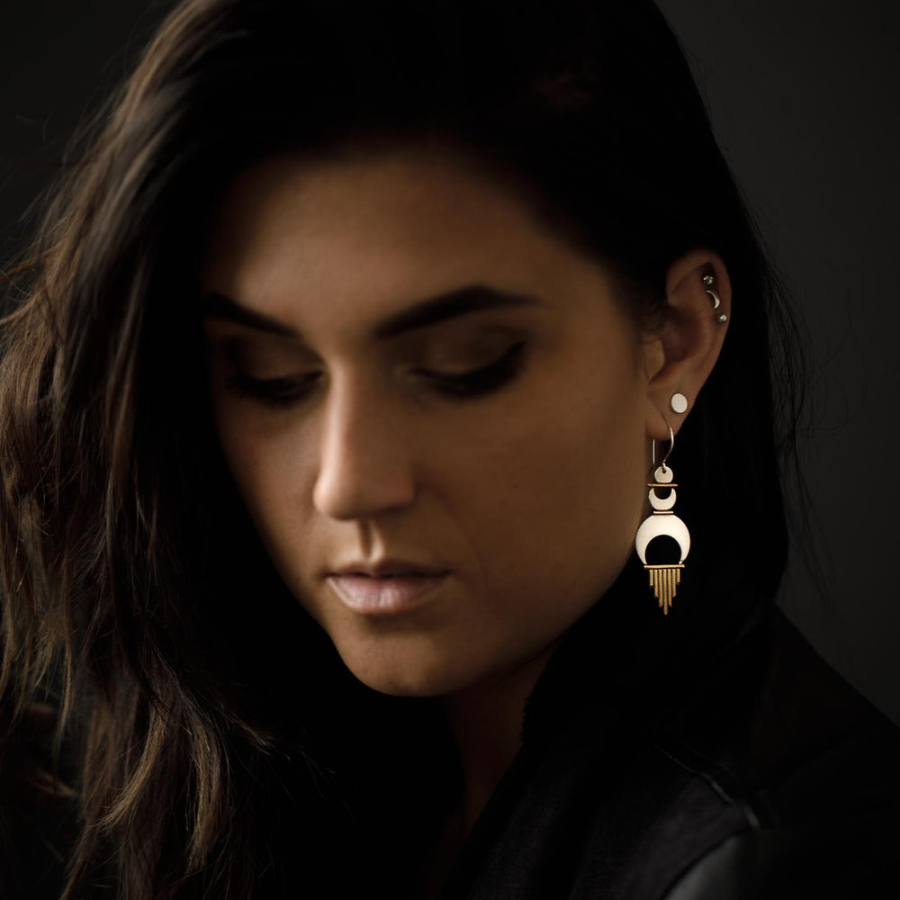 
                      
                        A statement earring paired with a minimal shiny dot stud for an added touch of femininity. 
                      
                    