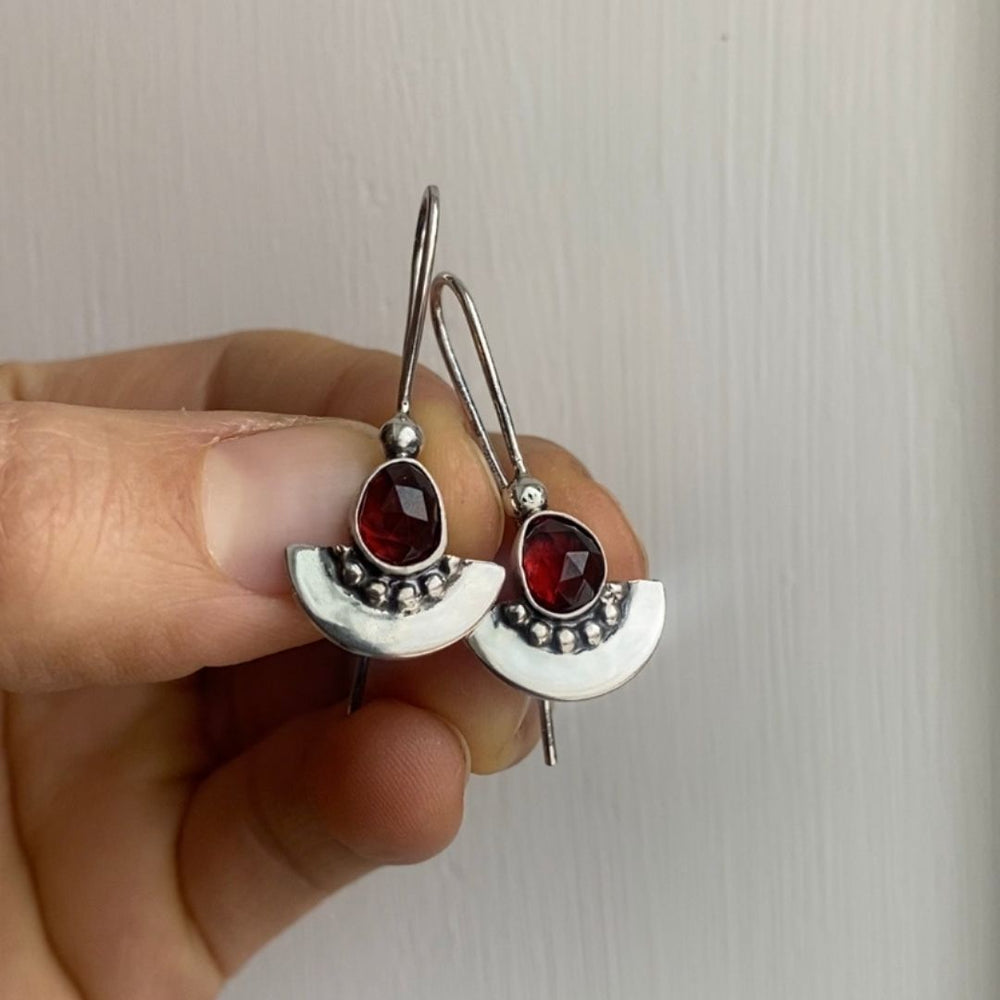 
                  
                    Garnet Shield Earrings
                  
                
