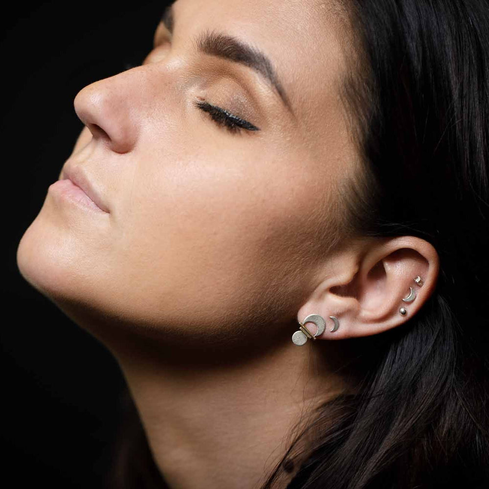 
                  
                    Basking in a warm glow while wearing multiple stud earring from the Alchemy Collection
                  
                