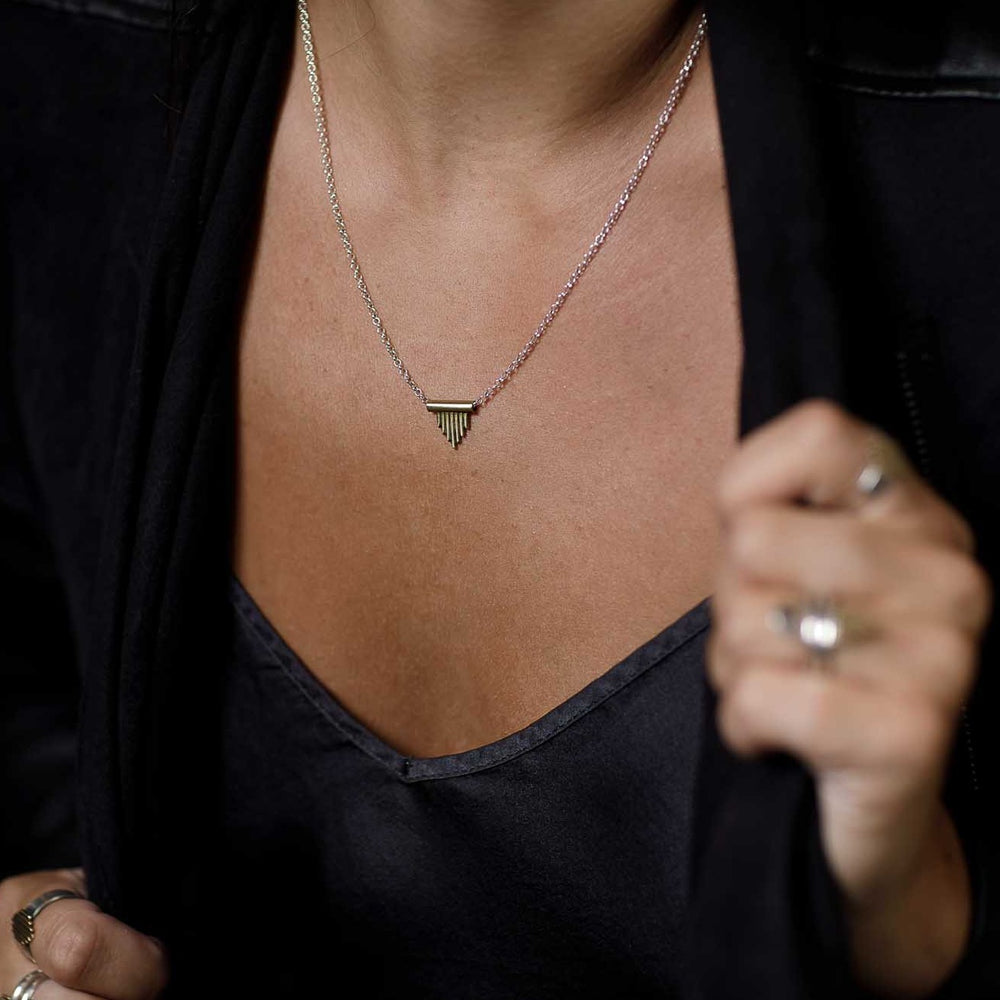 
                      
                        A woman on the go wears her Sun Ray Pendant to remind her of her motivation and her drive. 
                      
                    